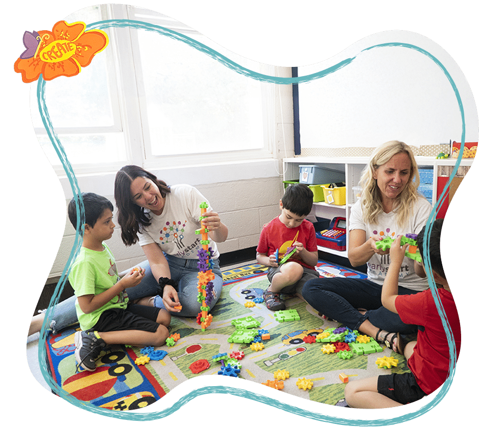 Children and teachers playing in a bright, colorful preschool classroom.